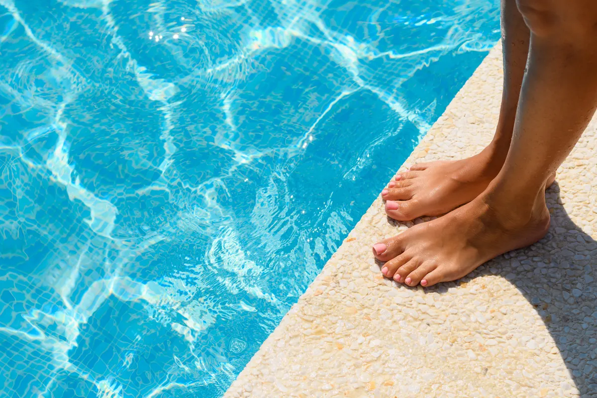 Feet by the pool edge